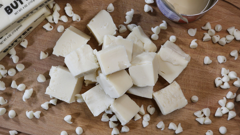 Photo aérienne d'une pile de piéciens de fudge au chocolat blanc sur une planche à découper en bois